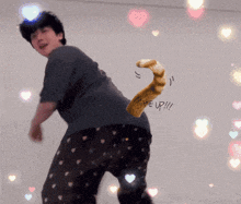 a man in pajamas is dancing with a drawing of a cat 's tail that says wake up !!!