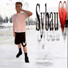 a boy in a pink shirt and black shorts stands in front of a sign that says sybau