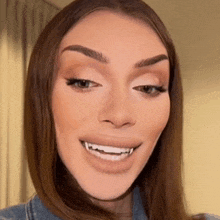 a close up of a woman 's face with a fake smile on it