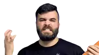 a man with a beard is holding a lime and making a face .
