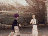 a man with purple hair is standing next to another man in white pants