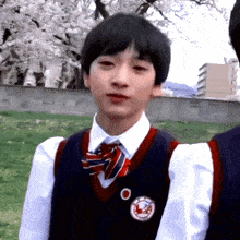 a boy in a school uniform has a badge on his chest that says ' u.s. army ' on it