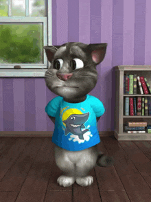 a cartoon cat wearing a blue shirt with a picture of a shark on it