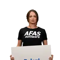 a woman is holding a sign that says afas software balen