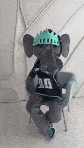 an elephant mascot wearing a crown and a shirt that says low