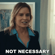 a woman says not necessary in front of a framed picture