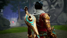 a man in a red and gold outfit is holding a gold and turquoise object