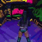 a woman in a wrestling ring with the word rodigy on her underwear