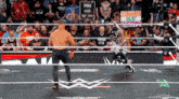 two wrestlers in a ring with a sign that says " summerslam " on it