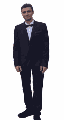 a man in a tuxedo giving a thumbs up