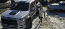 a man standing next to a truck that has the word tundra on it