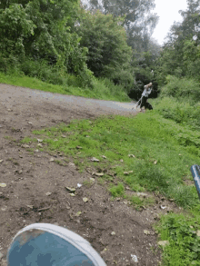a person walking a dog on a leash down a dirt path