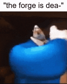a cat is laying on a blue object with the words " the forge is dea "