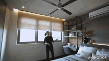 a woman is standing in a bedroom with a ceiling fan and says made in animotica