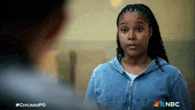a woman in a denim jacket with nbc on the back