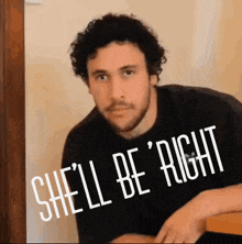 a man with a beard is wearing a black shirt that says " shell be right "