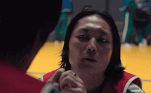 a man with long hair looks at another man