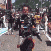 a man walking down a street with a bottle of monster energy drink