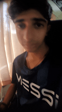 a young boy wearing a shirt that says messi on it