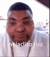 a close up of a man 's face with the words mojaclito rizz on the bottom .