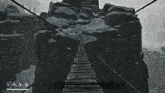 a screenshot of a video game shows a bridge between two mountains