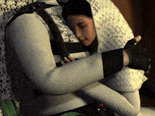 a man and a woman are hugging each other and the man is wearing a white jacket