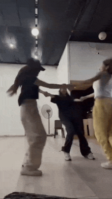a group of young women are dancing in a dance studio .