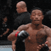 a shirtless fighter wearing a pair of boxing gloves