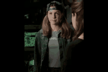 two girls are standing next to each other in a dark room .