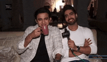 two men are sitting on a couch with a microphone in front of them and the caption says courtesy starplus