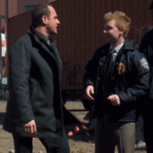 two men are standing next to each other and one has a patch on his jacket that says ' u.s. army '