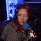 a woman with red hair wearing headphones and a microphone
