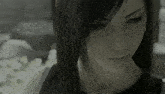 a close up of a woman 's face with long black hair
