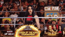 a woman in a wrestling ring with a sign that says cm punk in the background
