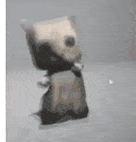 a blurred image of a stuffed animal with a bow tie on its neck .