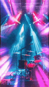 a drum set is on a stage with purple lights