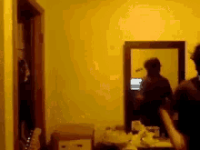 a man standing in front of a mirror in a room