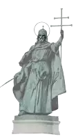 a statue of a man holding a cross and a sword has the name szent isivan on the base