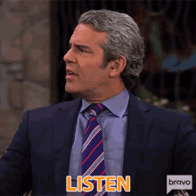 a man in a suit and tie is saying listen .