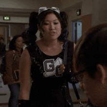 a cheerleader wearing a black top with the letters gc on it