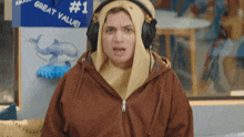 a person wearing headphones stands in front of a sign that says great value # 1