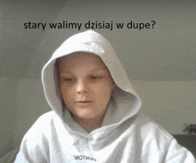 a young boy wearing a white hoodie with the words " stary walimy dzisiaj w dupe " on the bottom