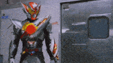 a man in a robot costume is standing in front of a door with a sticker on it that says ' a '