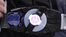 a person is wearing a black belt with a purple u logo on it