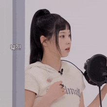 a girl singing into a microphone with the words ii ? written on the bottom