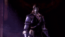 a man in a purple suit is standing in a dark room with a purple background .