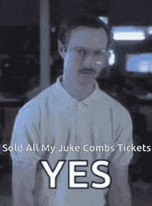 a man with glasses and a mustache is giving a yes sign