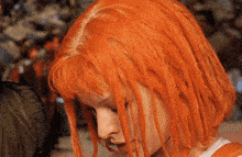 a close up of a woman with orange hair