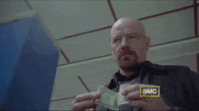 a man is holding a piece of paper that says smart