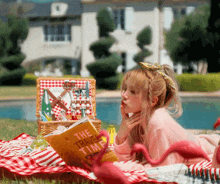 a girl laying on a blanket reading a book titled the travel time